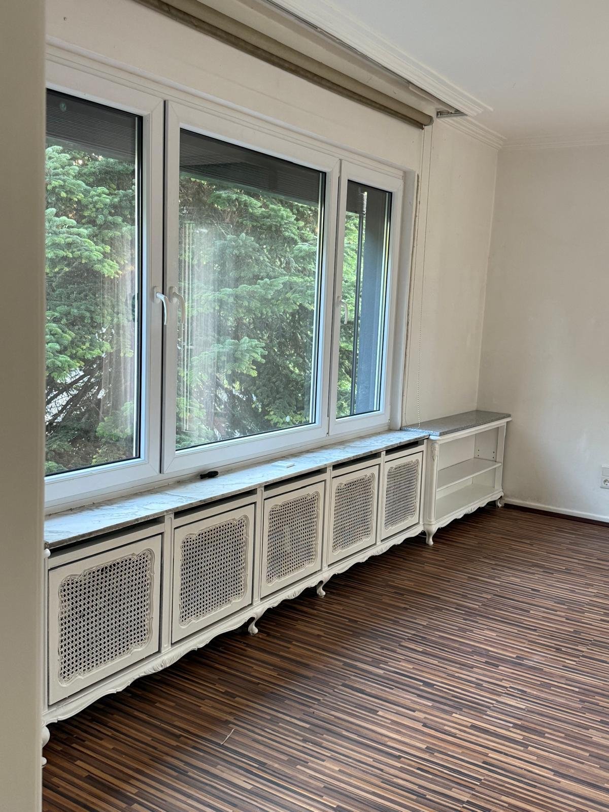 Brightly lit ambiance: Stylish radiator cover with elegant privacy screen and panoramic view of greenery Brightly lit ambiance: Stylish radiator cover with elegant privacy screen and panoramic view of greenery