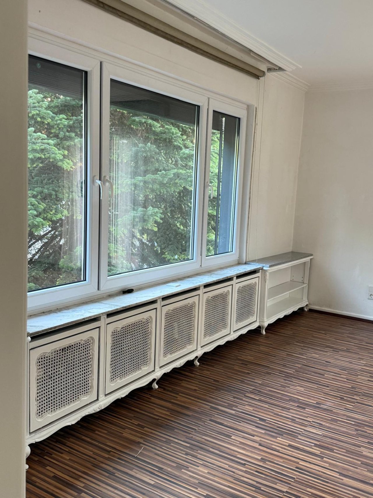 Brightly lit ambiance: Stylish radiator cover with elegant privacy screen and panoramic view of greenery Brightly lit ambiance: Stylish radiator cover with elegant privacy screen and panoramic view of greenery