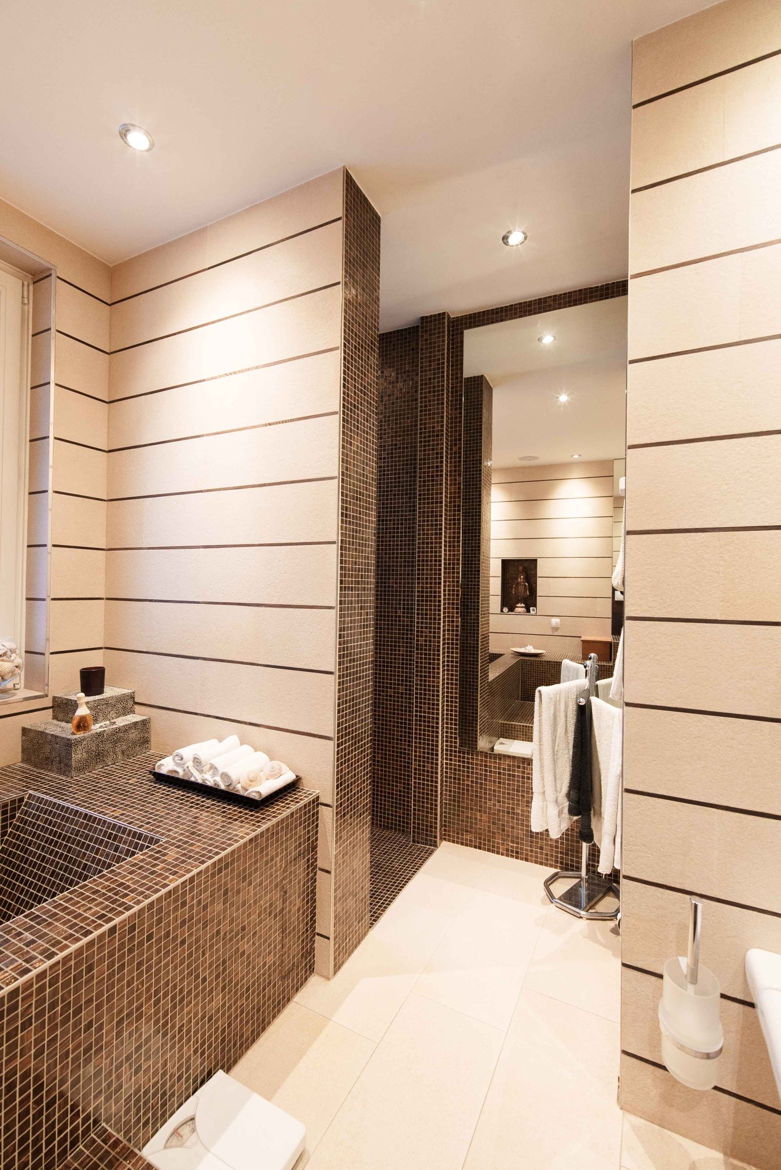 Wellness oasis with thoughtful layout: modern bathroom with elegant mosaic surface and spacious shower area Wellness oasis with thoughtful layout: modern bathroom with elegant mosaic surface and spacious shower area