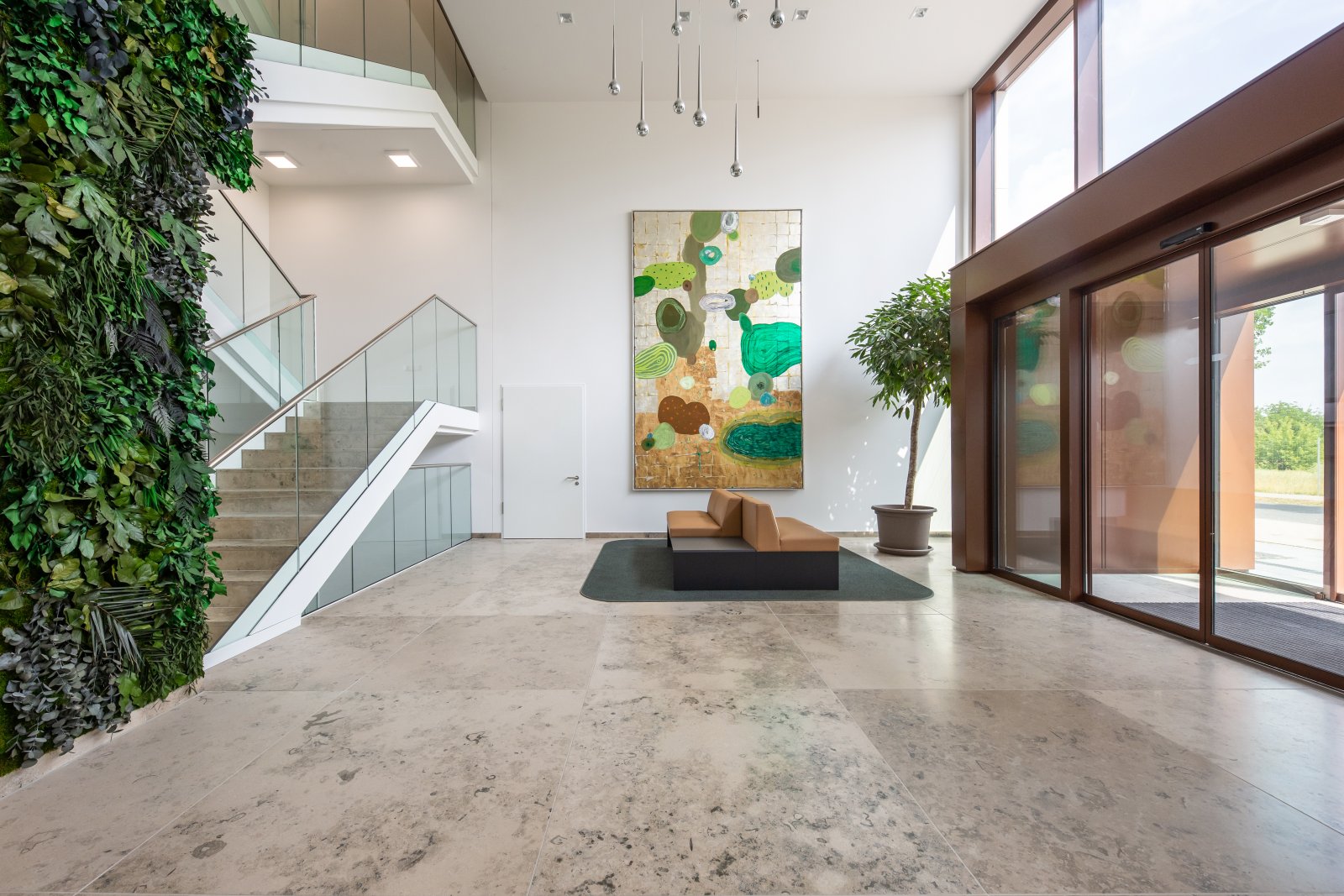 Brightly lit design oasis with a vertical garden wall and spacious glass architecture - your entrance to well-being! Brightly lit design oasis with a vertical garden wall and spacious glass architecture - your entrance to well-being!