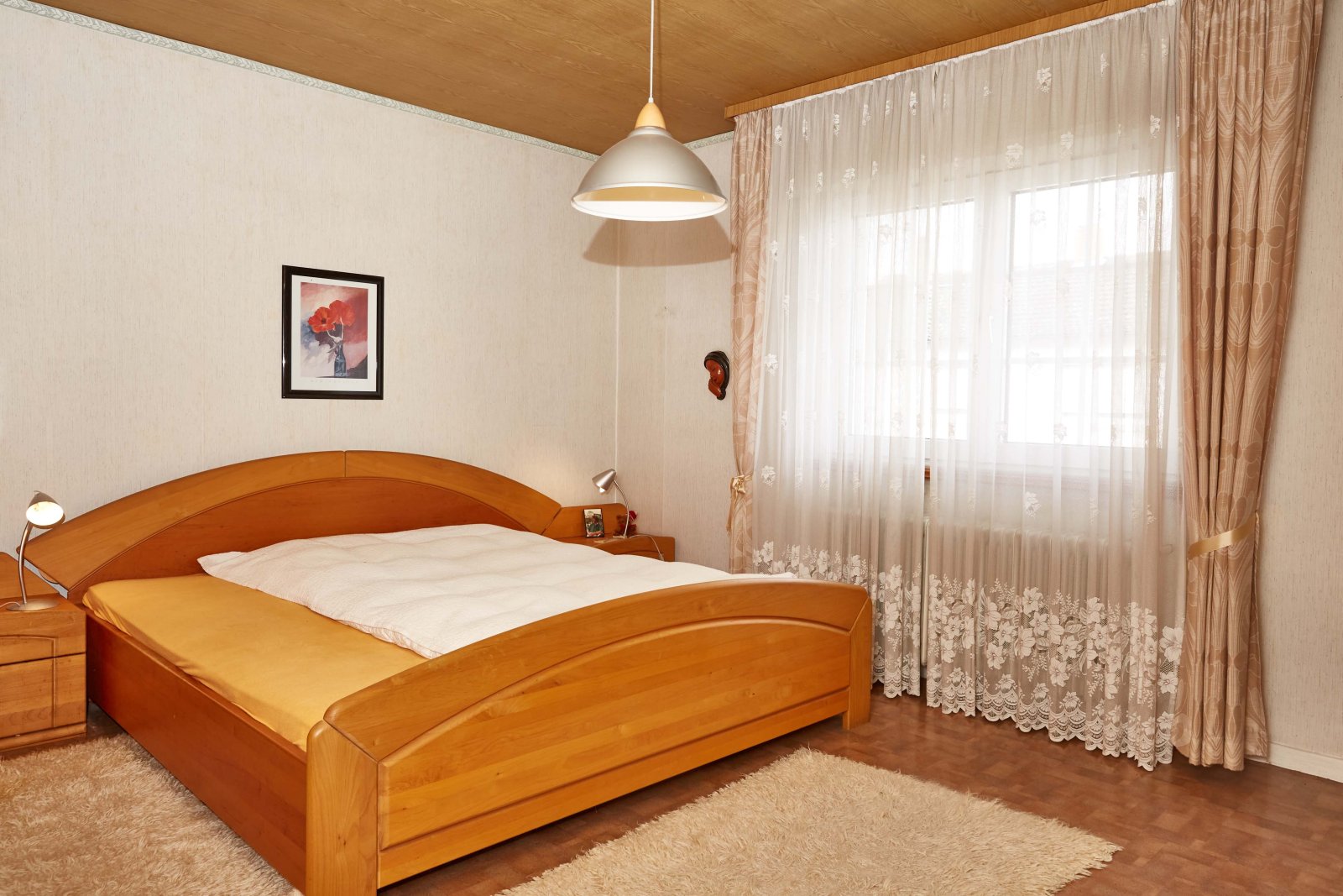 Bright bedroom with large windows and high-quality furnishings