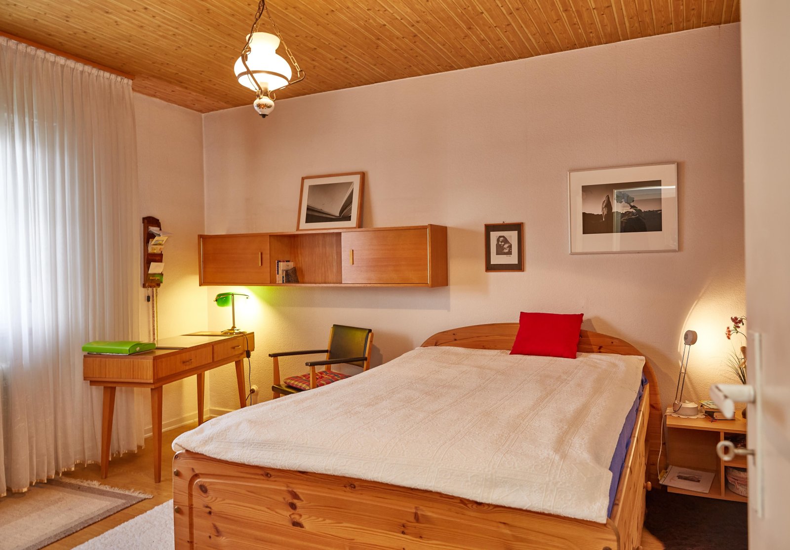 Bedroom with a distinctive wooden ceiling beam and practical layout