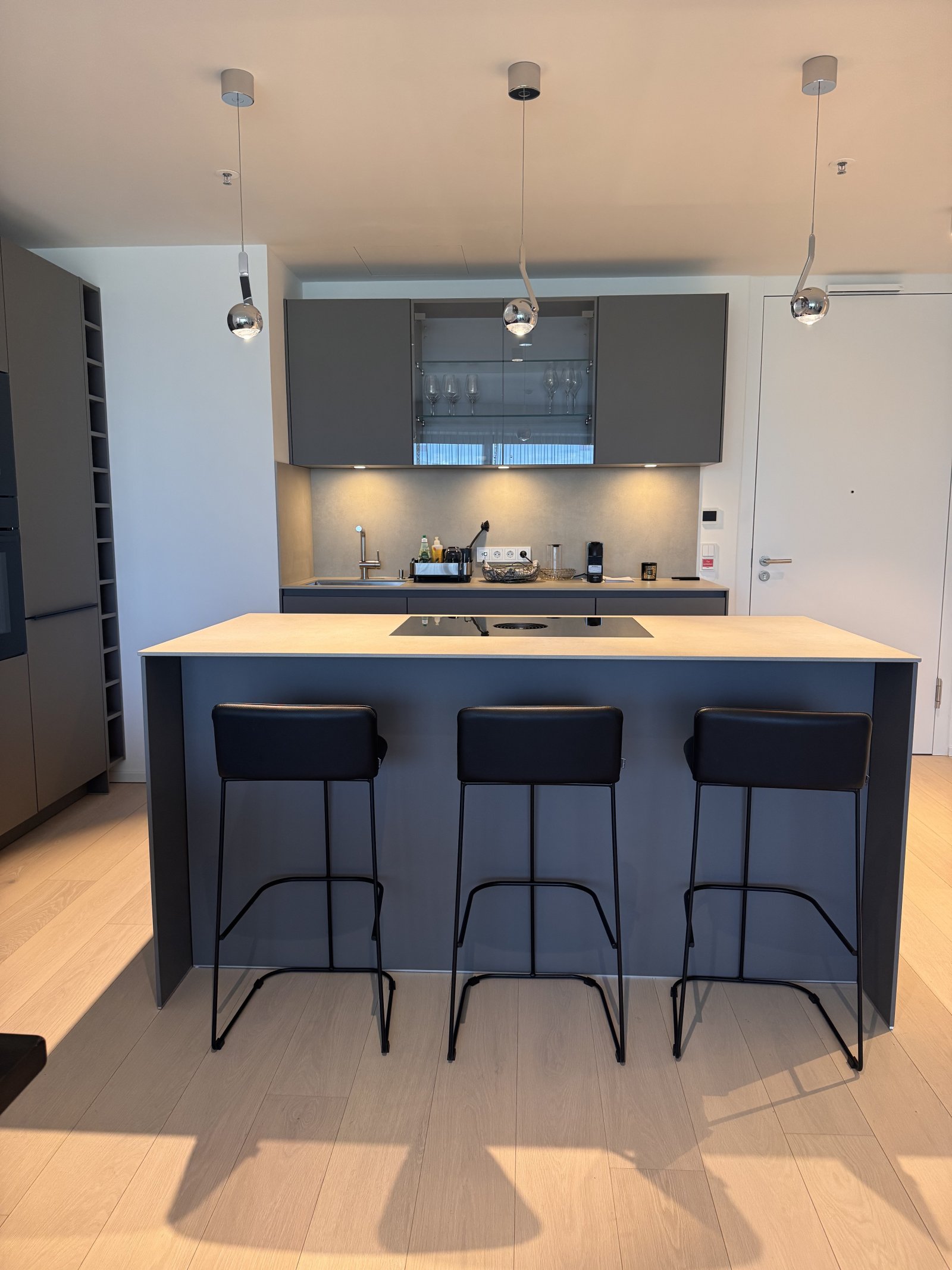 Modern kitchen architecture with a central kitchen island and integrated bar.