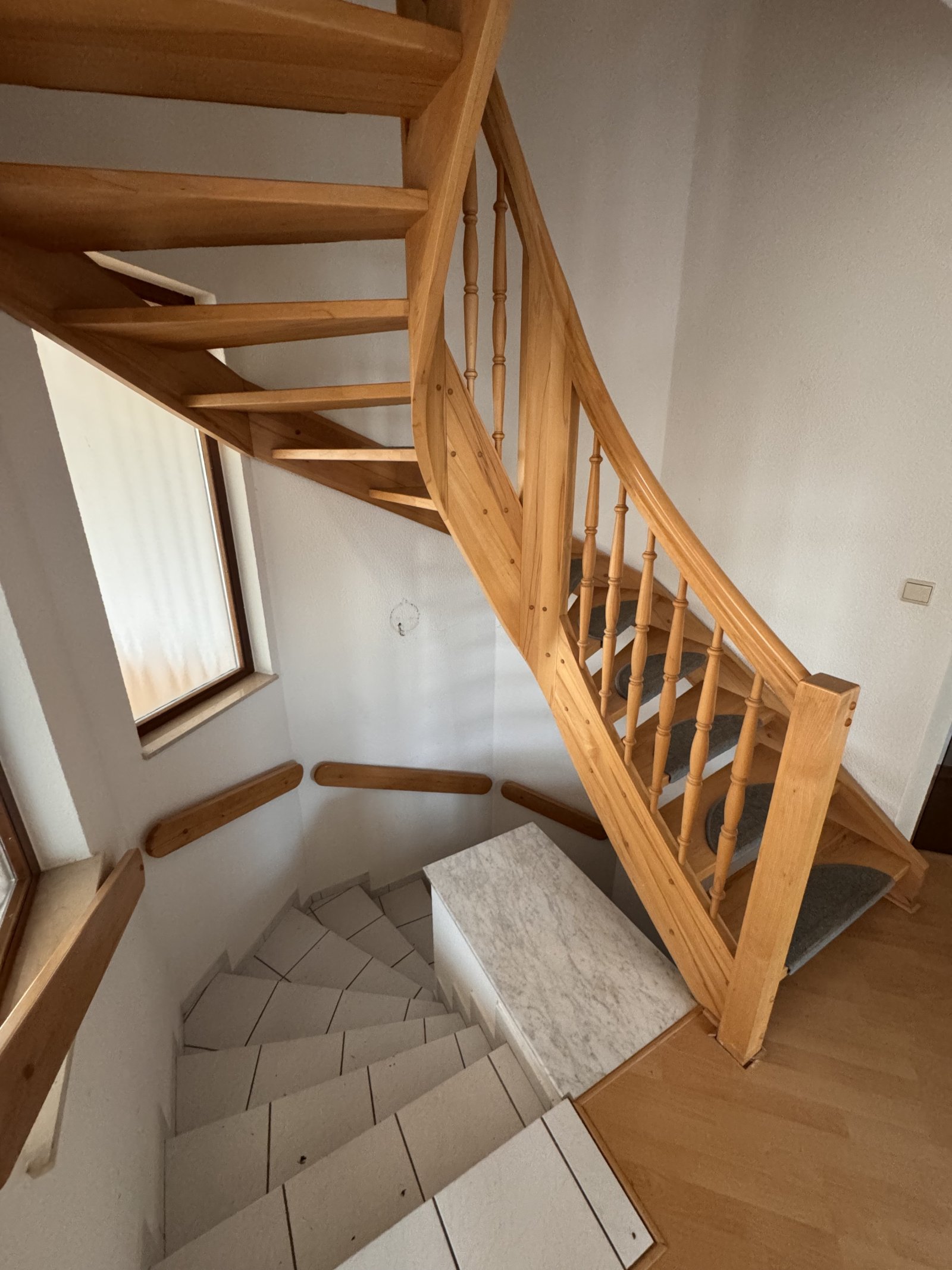 Elegant wooden staircase with thoughtful space layout and natural lighting