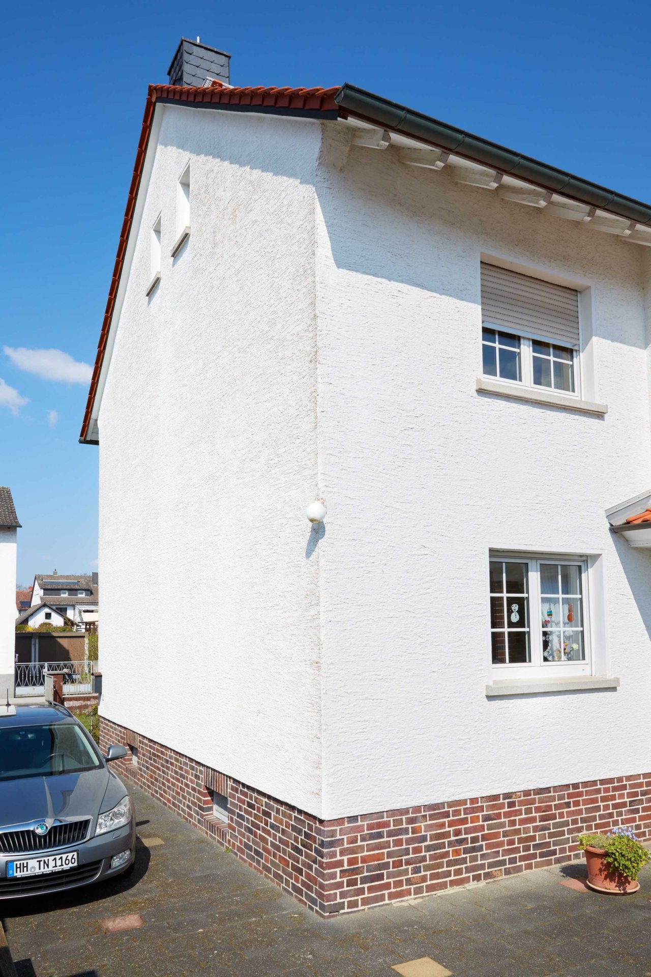 Solid building structure with a classic facade and modern window units.