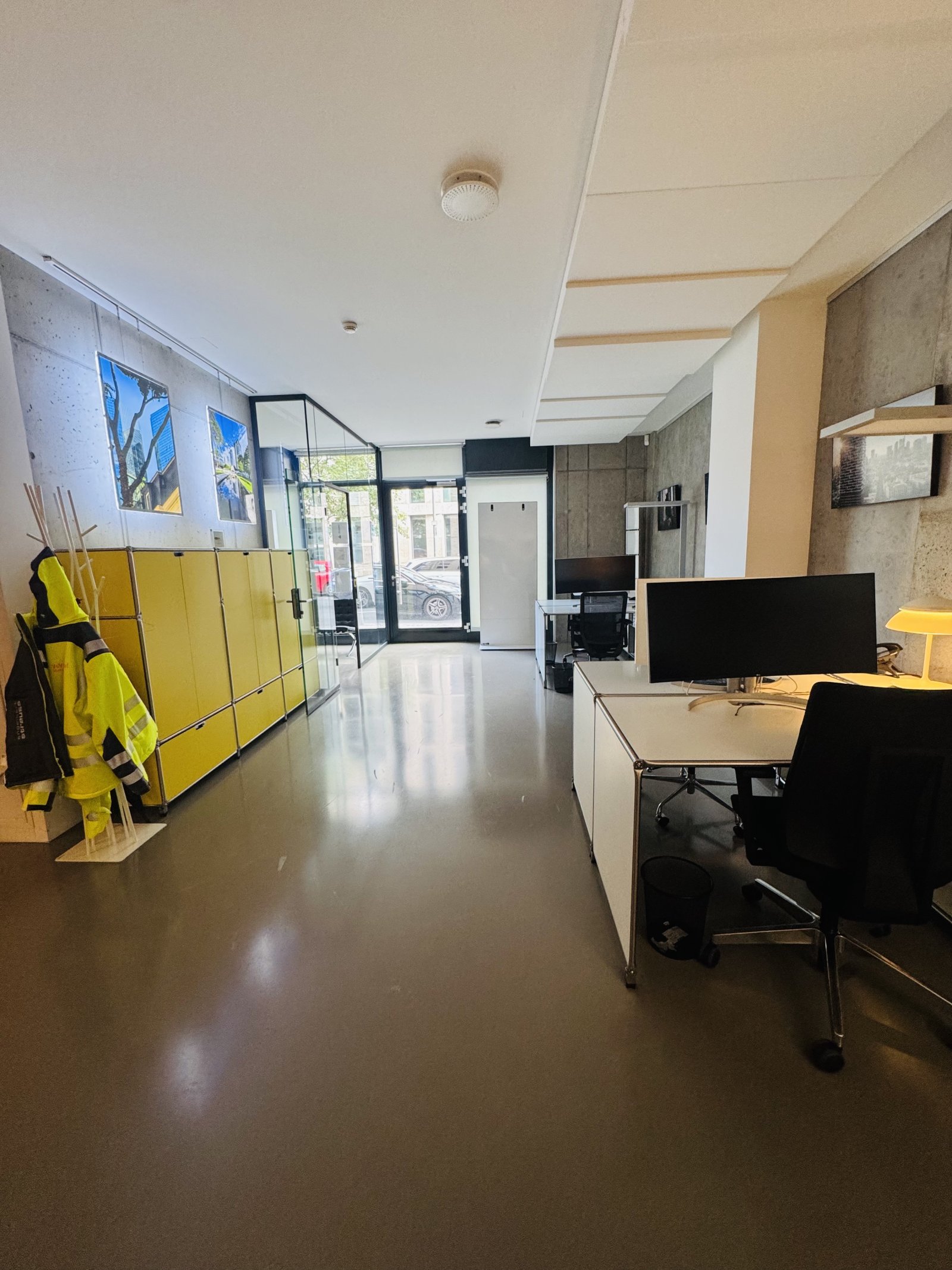 Bright office with open floor plan and modern concrete accents Bright office with open floor plan and modern concrete accents