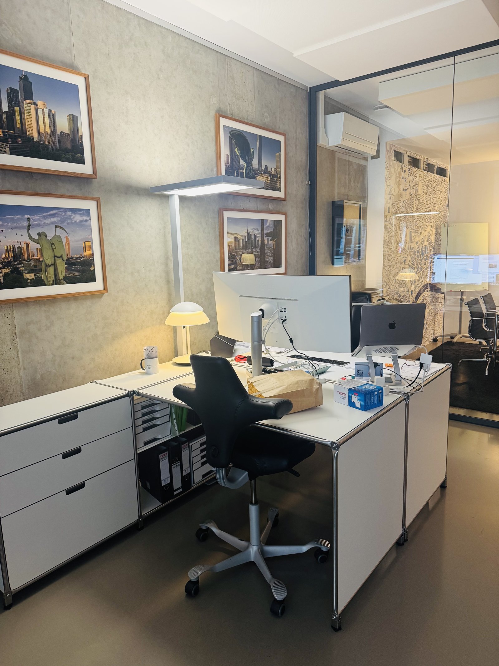 Professional office with integrated glass partition and optimized workspace layout